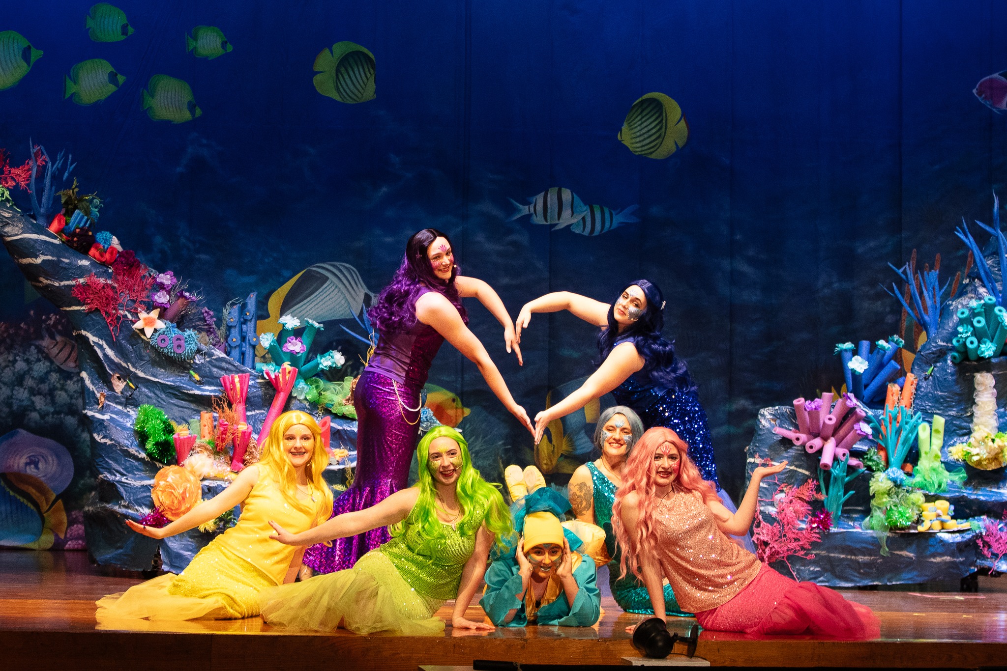 Mermaids under the sea performing a dance