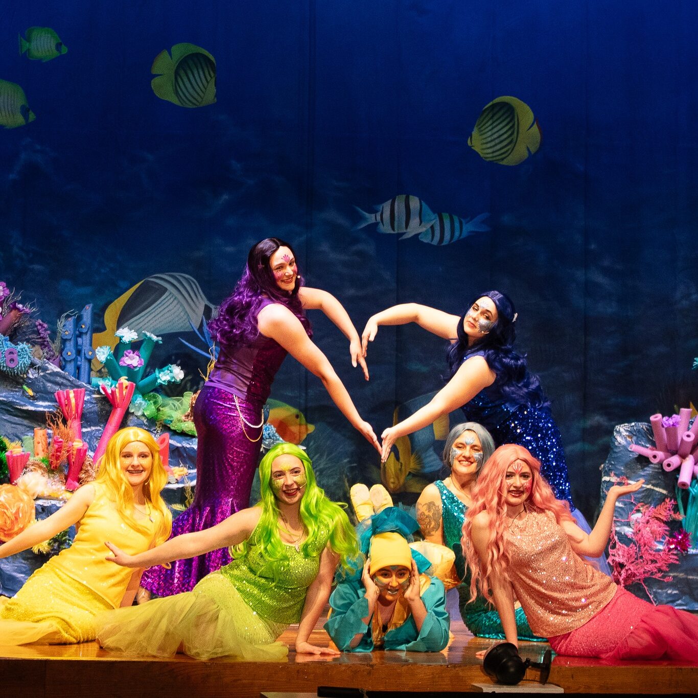 Mermaids under the sea performing a dance